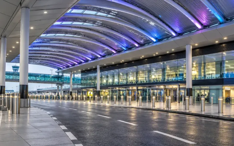 Gatwick Airport terminal forecourt under a curved, lit canopy